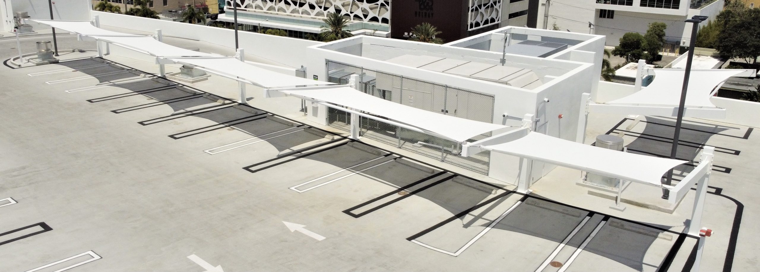 white modern Shade Structure over a rooftop parking lot